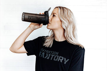 Woman in Black T-Shirt drinking pre workout in Nutrition Faktory Shaker bottle